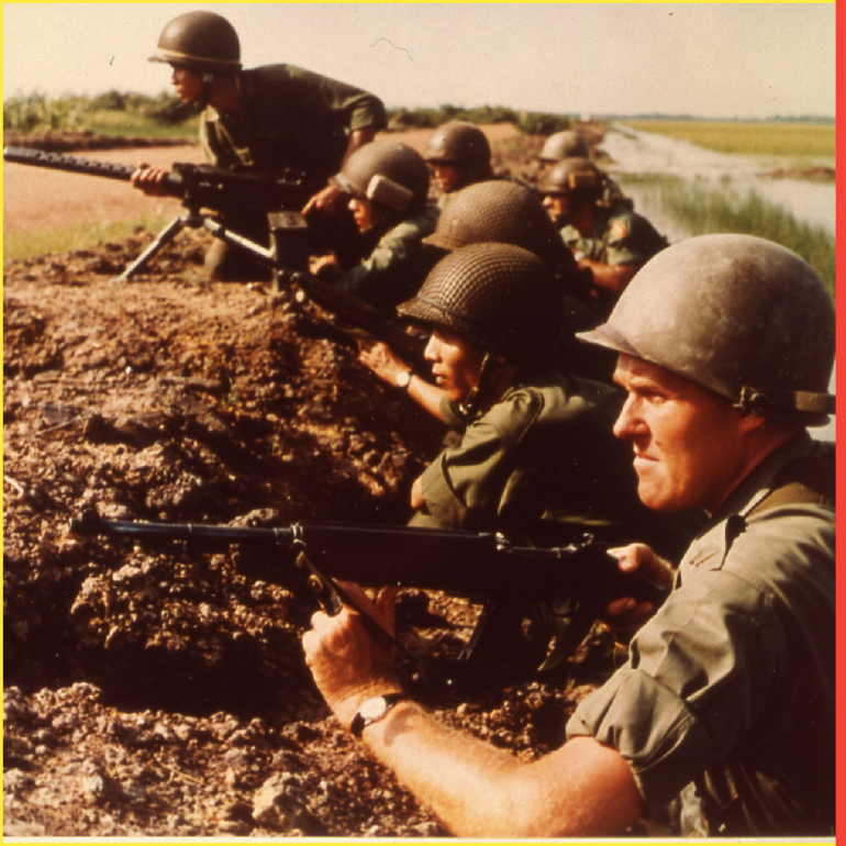 U.s. Army Advisors And Vietnamese Infantrymen Await Attack Along Bank Of A Rice Paddy