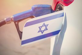 Flag of Israel on the car's fuel filler flap with gas pump nozzle in the tank; Shutterstock ID 681644965; purchase_order: AJA; job: ; client: ; other: