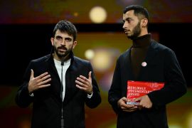 Israeli director Yuval Abraham (L) and Palestinian director Basel Adra speak on stage after having received the Berlinale documentary award for 'No Other Land' during the awards ceremony of the 74th Berlinale International Film Festival, on February 24, 2024 in Berlin. (Photo by John MACDOUGALL / AFP)