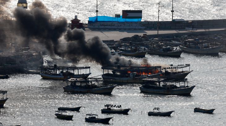 Smoke billows from a boat following Israeli strikes, at Port of Gaza, October 8, 2023. REUTERS/Mohammed Salem