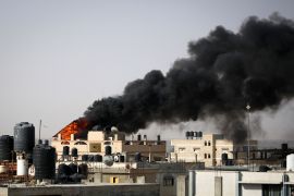دخان أسود كثيف يتصاعد من حريق في مبنى ناجم عن قصف إسرائيلي في رفح بجنوب قطاع غزة (الفرنسية)