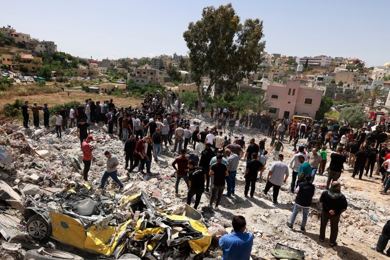 Palestinians inspect the damage after a raid by Israeli forces in the occupied West Bank town of Deir al-Ghusun near Tulkarem on May 4, 2024. (Photo by Jaafar ASHTIYEH / AFP)