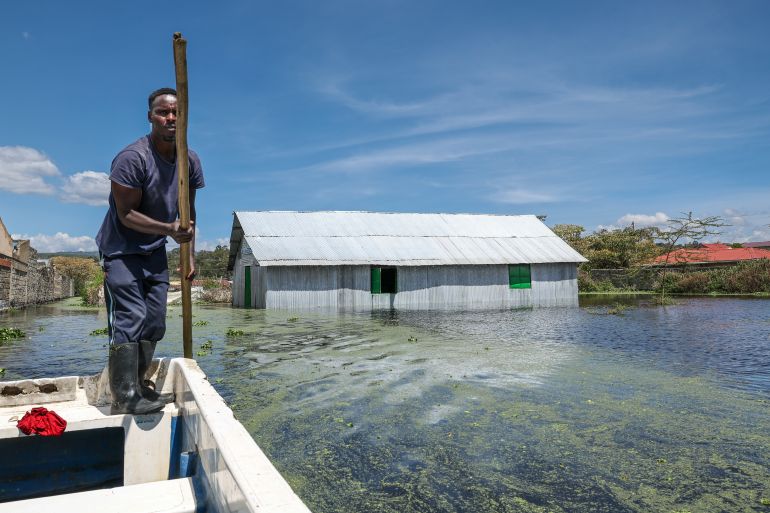 epa12519005 A Kenyan boat operator maneuverers within a flooded residential area as they continue to vacate people from their flooded homes affected by floods and raising backflow waters from Lake Naivasha which has been worsened by prolonged rainfall in Kihoto Esatate, in the Lakeview award, in Naivasha, about 90km northwest of Nairobi, in the rift valley, Kenya, on 11 November 2025. Thousands of residents of Kihoto Etate, in Naivasha, Nakuru County, have been affected by floods caused by the rising waters of Lake Naivasha. Water levels has been rising to unprecedented levels that has been expanding the lake since 2020, among other lakes in the Rift Valley that have been steadily rising. EPA/DANIEL IRUNGU